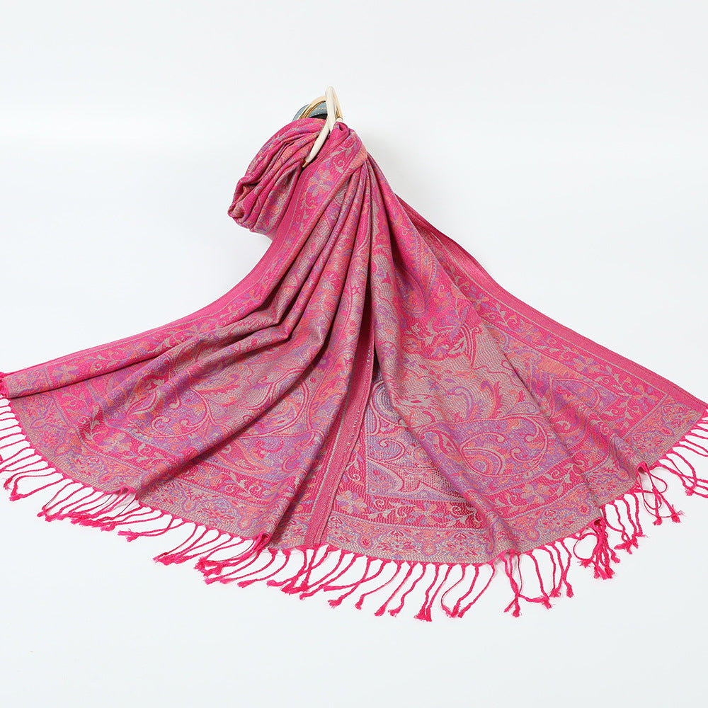 Fuchsia paisley jacquard scarf spread on a white background with twisted fuchsia tassel fringe