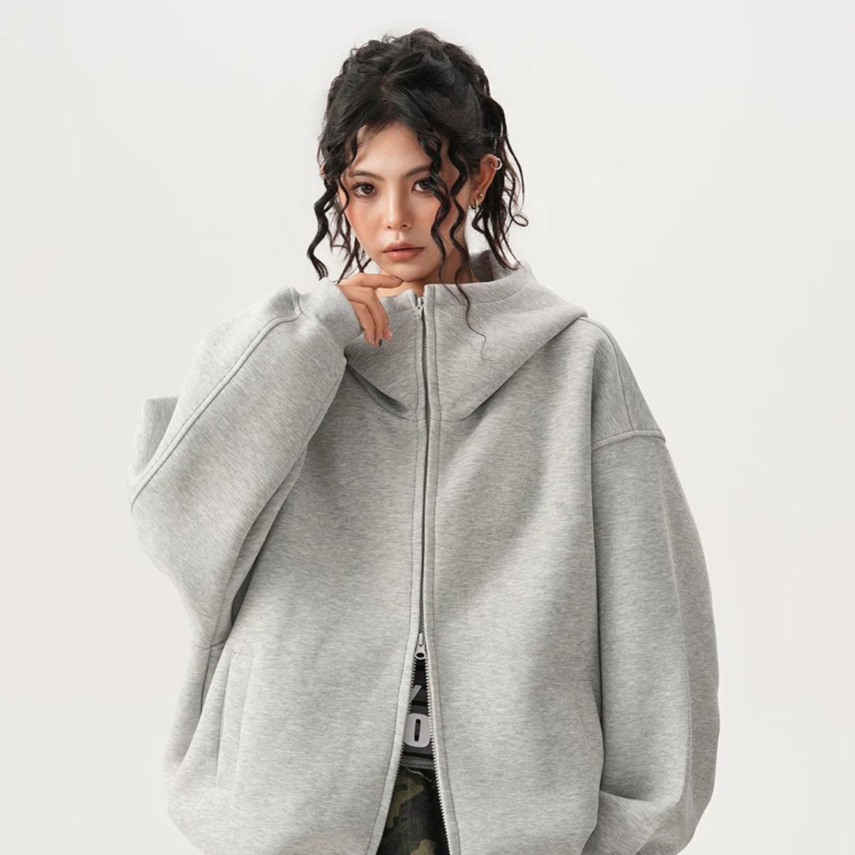 Heather grey heavyweight hooded sweatshirt with the two way zipper partly open