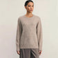 Detail close up of the even-gauge knit texture and ribbed cuff on the sweater