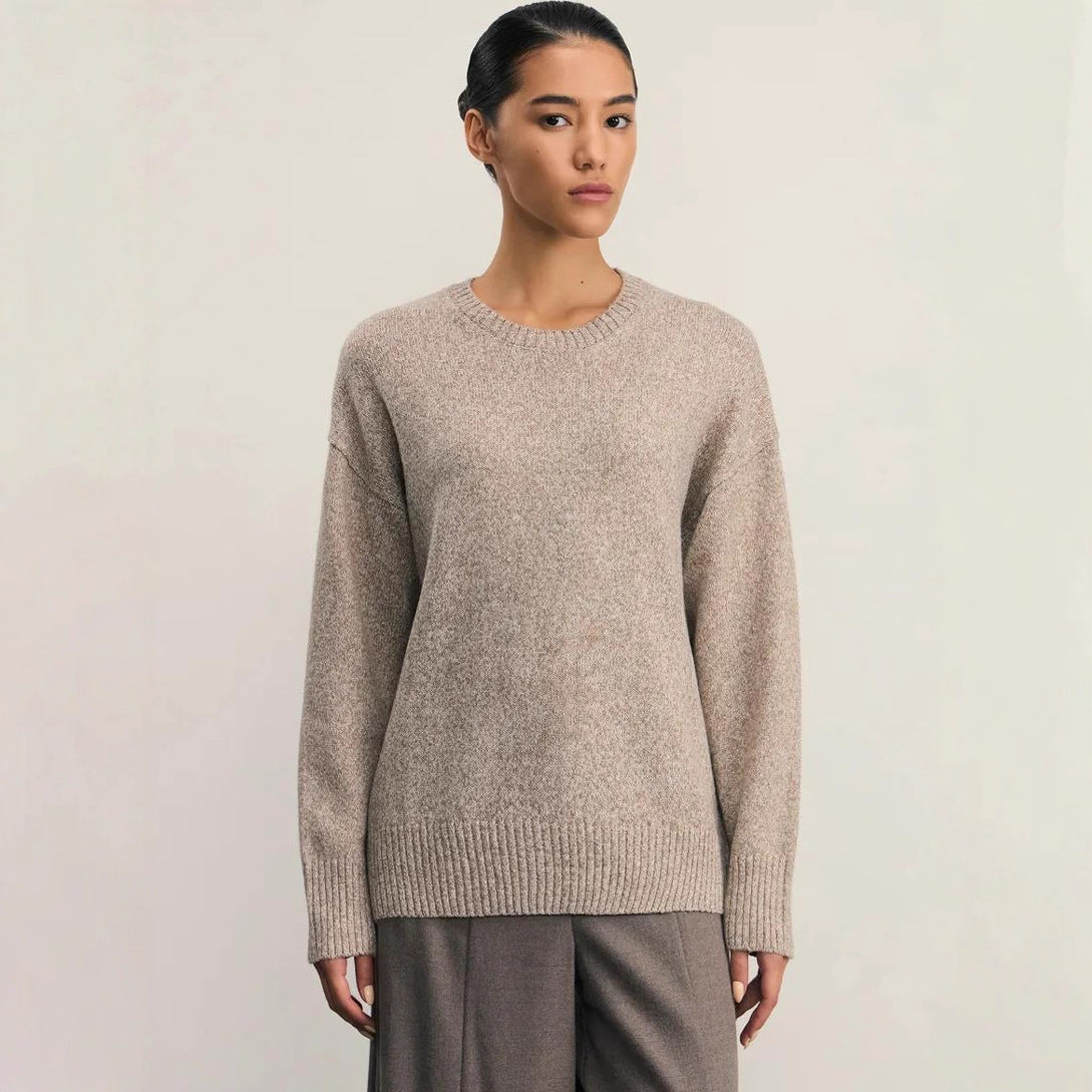Detail close up of the even-gauge knit texture and ribbed cuff on the sweater
