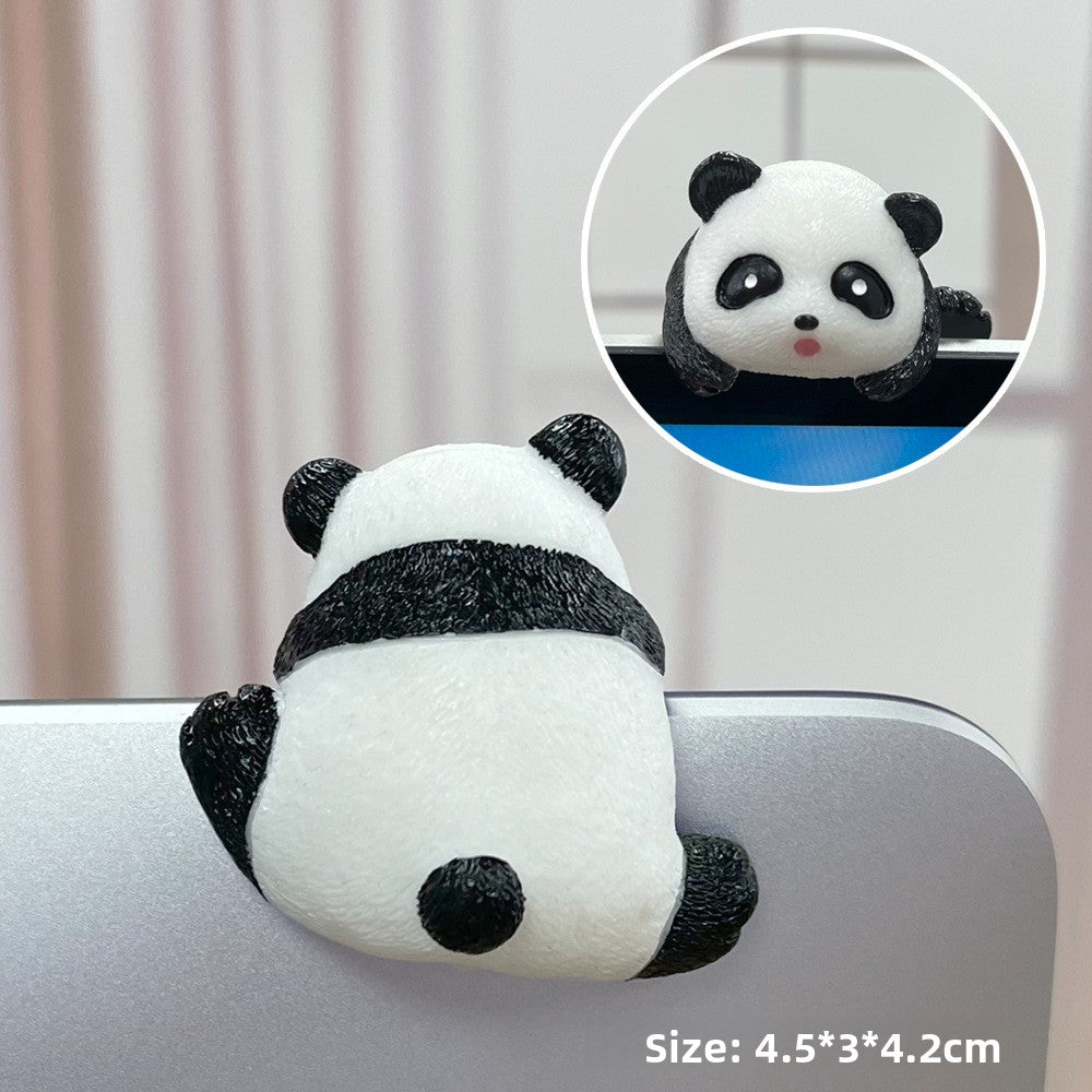 Black and white panda resin figurine straddling a laptop edge with a front view inset