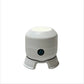 White cylindrical rotating projector night light with a power button on a three footed base, front view