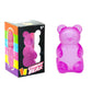 Purple gummy bear squishy toy beside its printed 3+ box