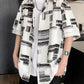 Loose short sleeve print shirt shown from the front, buttons running collar to hem