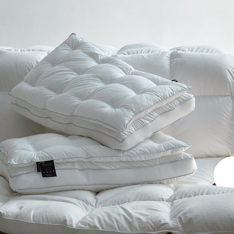 White quilted cotton sateen bed pillow with mesh gusset stacked on a bed
