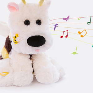 Close up of the bee puppy plush face with a black nose beside floating music notes