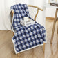 Blue and white plaid coral fleece blanket in 140 x 200 cm draped over a wooden chair