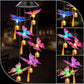 Butterfly LED figures with golden bells and tassels hanging from a solar lamp head, black housing option