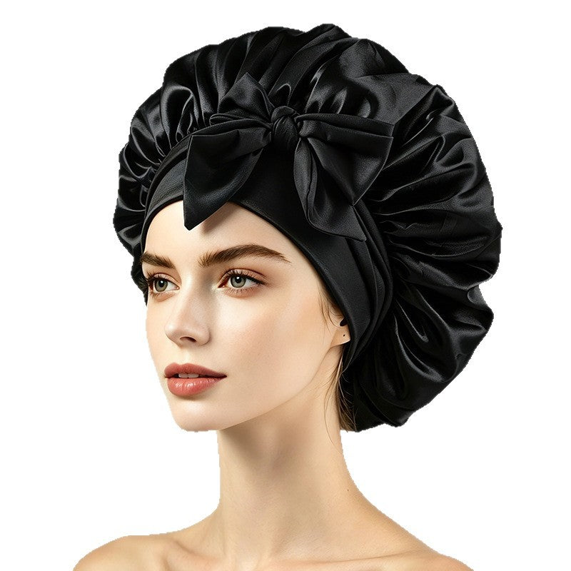 Adjustable satin bonnet with tie straps, worn to protect hair overnight