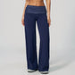 Model in wide leg pants with a fold over printed waistband, navy with white polka dots