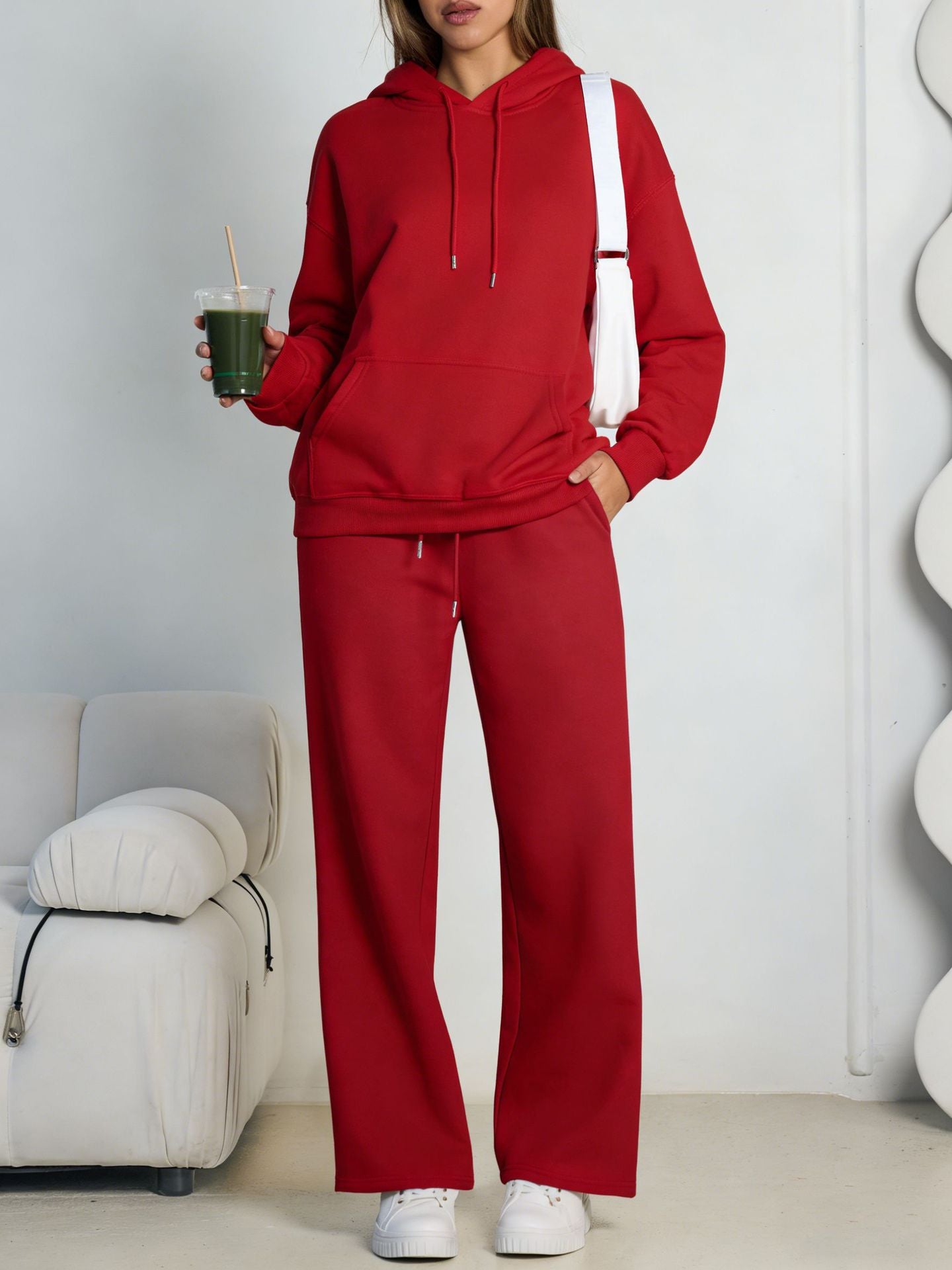Red fleece hooded sweatshirt and wide-leg sweatpants set worn by a model