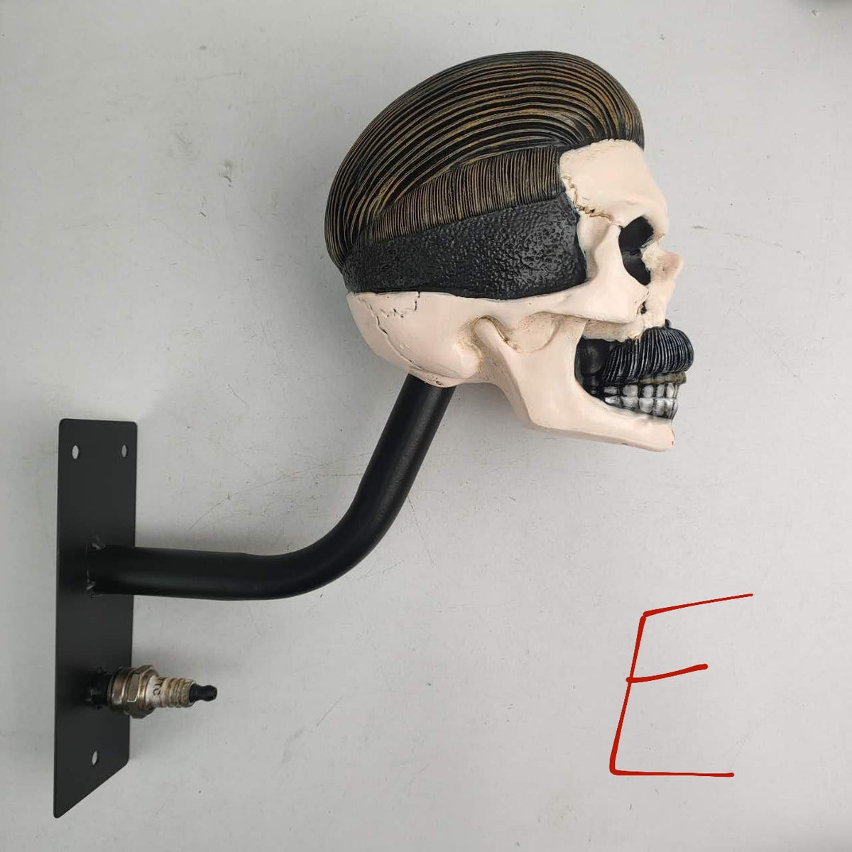 Resin skull helmet rack shown without a helmet as a standalone wall sculpture