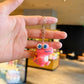 Angled hero shot of the cartoon dinosaur keychain charm
