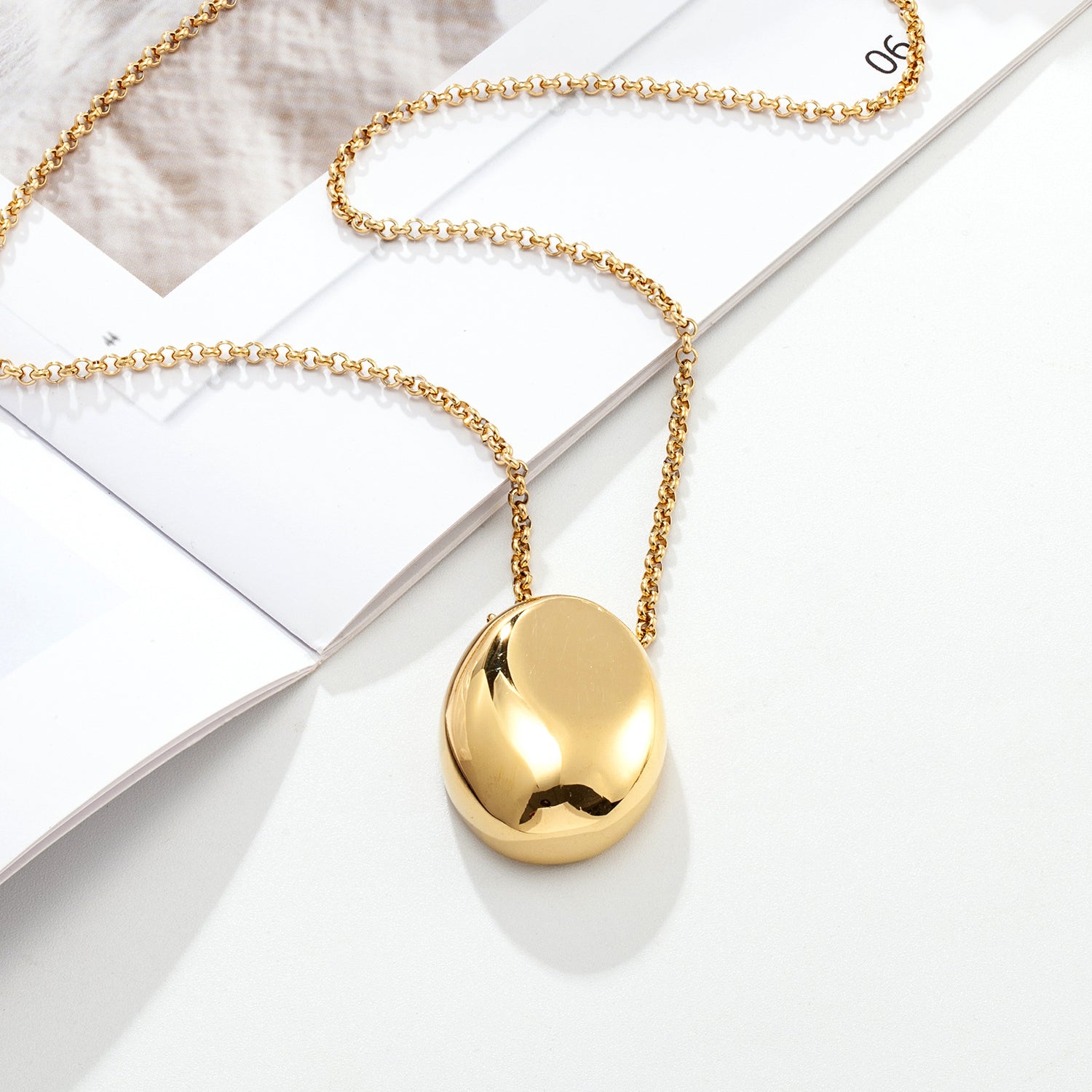Close up of drop pendant and plated chain links detail