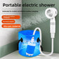 Portable electric shower head spraying beside a pump submerged in a blue bucket of water
