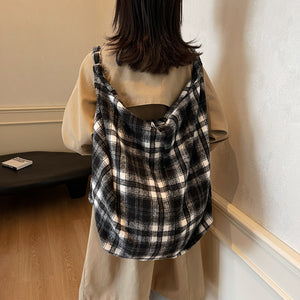 Brown checked woolen shoulder tote bag shown from the side with its soft slouchy body