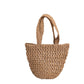 Tan paper straw shoulder bag with braided straps shown against a plain background