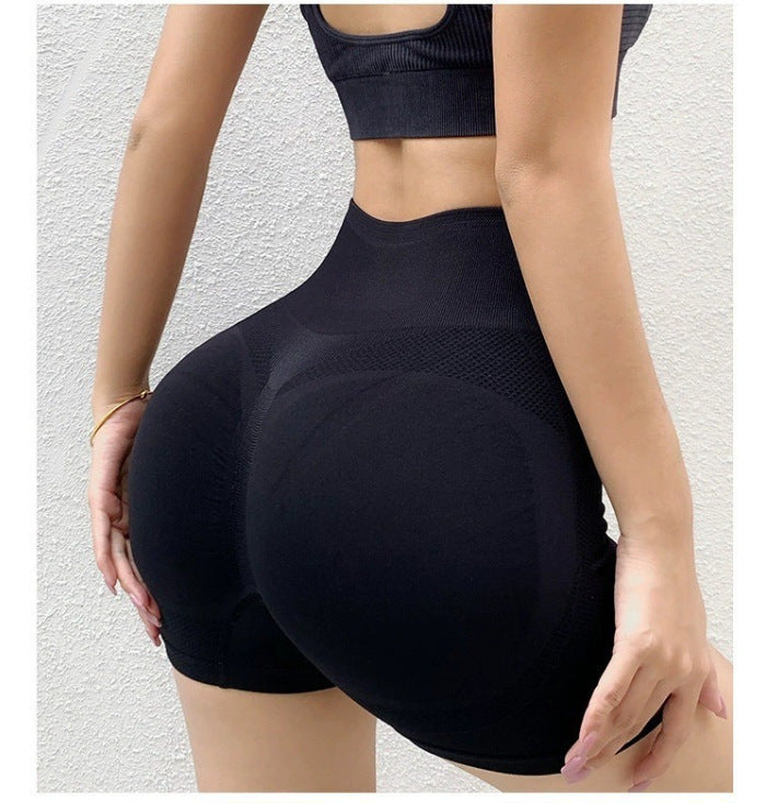 Black yoga shorts rear view, mid thigh hem and no side seam along the leg