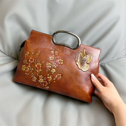 Embossed leather top handle handbag styled with a dressed up outfit