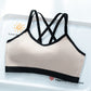 Beige milk coffee bra top with black trim and black crossed back straps on a white tray, Beige option, size XL