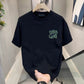 Black crew neck T-shirt on a hanger with a green hand-drawn scribble print, a print not among the listed options