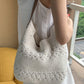 Off-white crochet shoulder bag with open floral weave bands