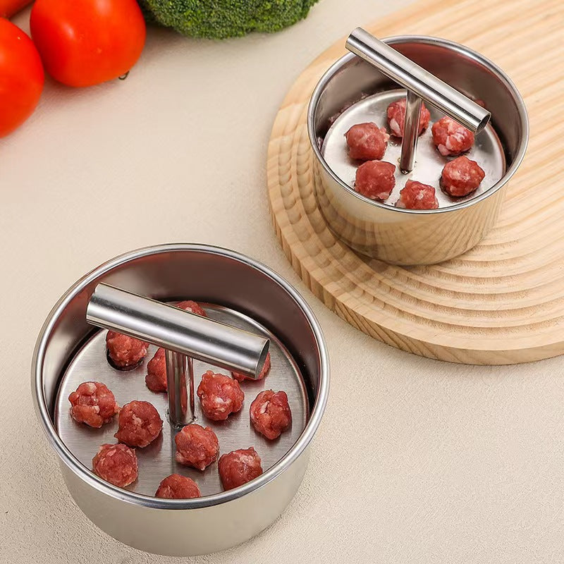 Stainless steel meatball press with a T handle plate and a drum holding fresh ground meat