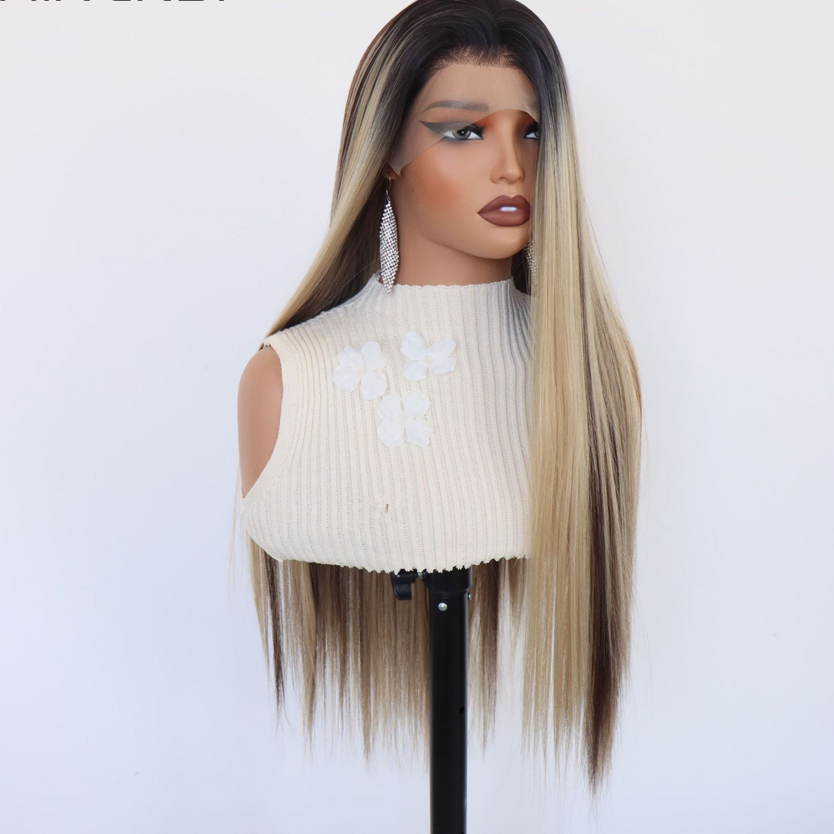 Three quarter front view of a long straight mixed blonde and brown lace front wig on a mannequin with a ribbed top