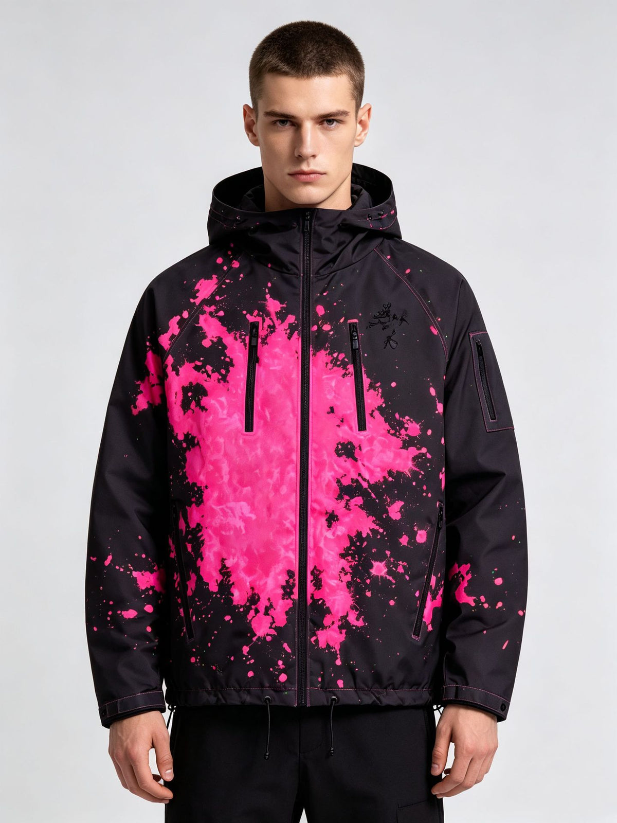 Man wearing the black hooded jacket with a magenta splash ink print, option photo for size S