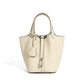 Leather bucket tote bag opening drawn closed under the metal clasp
