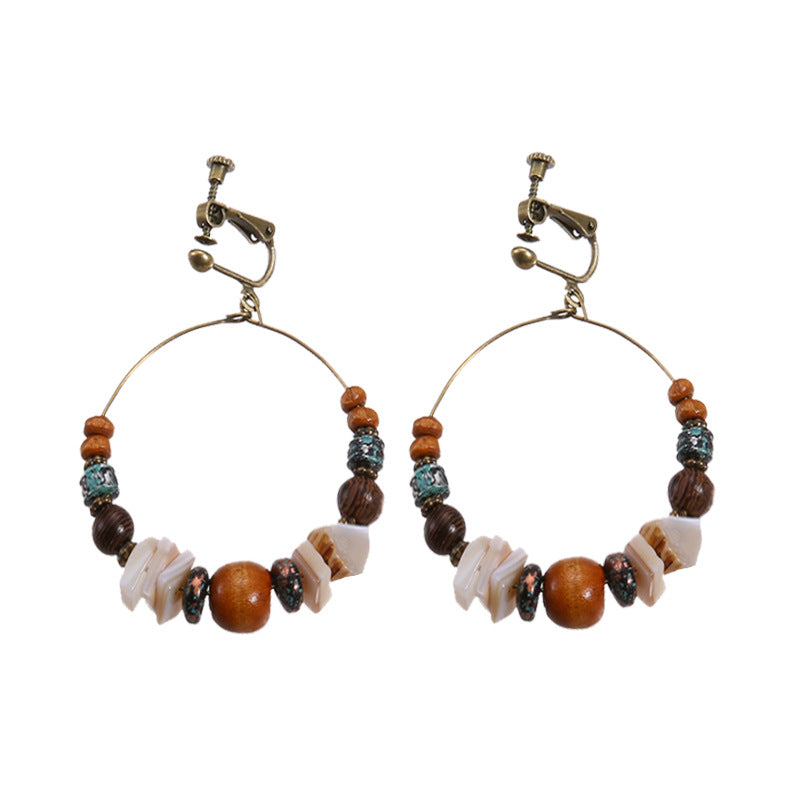 Boho vintage clip-on drop earrings with fringe and bead accents, zinc alloy build, studio image on white background