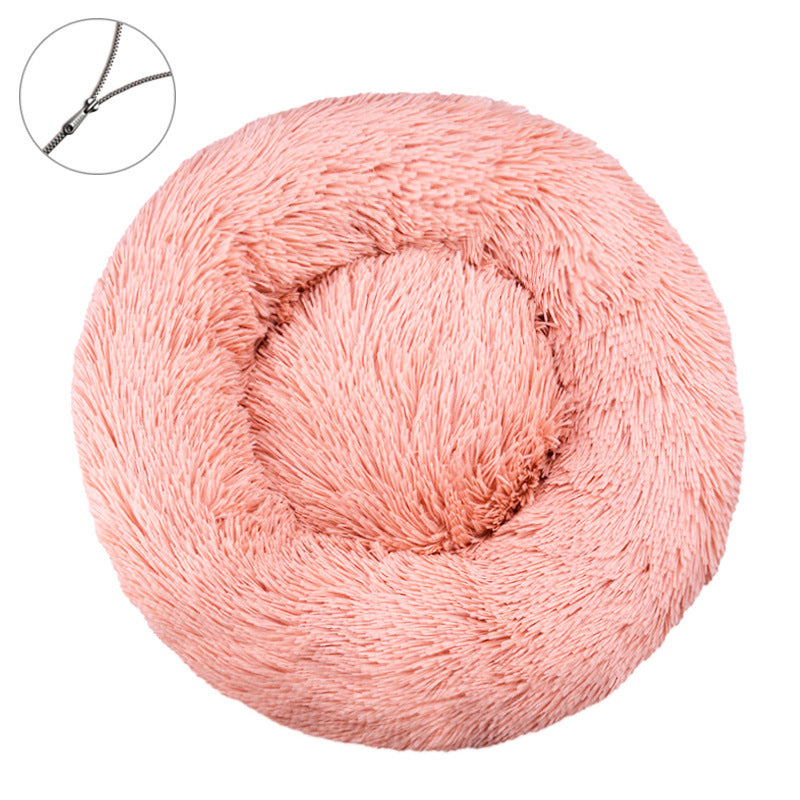 Peach pink round plush pet bed with a raised bolster rim on a plain background