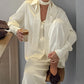 Front view of the buttercream long sleeve shirt and wide leg trousers two piece set on a woman