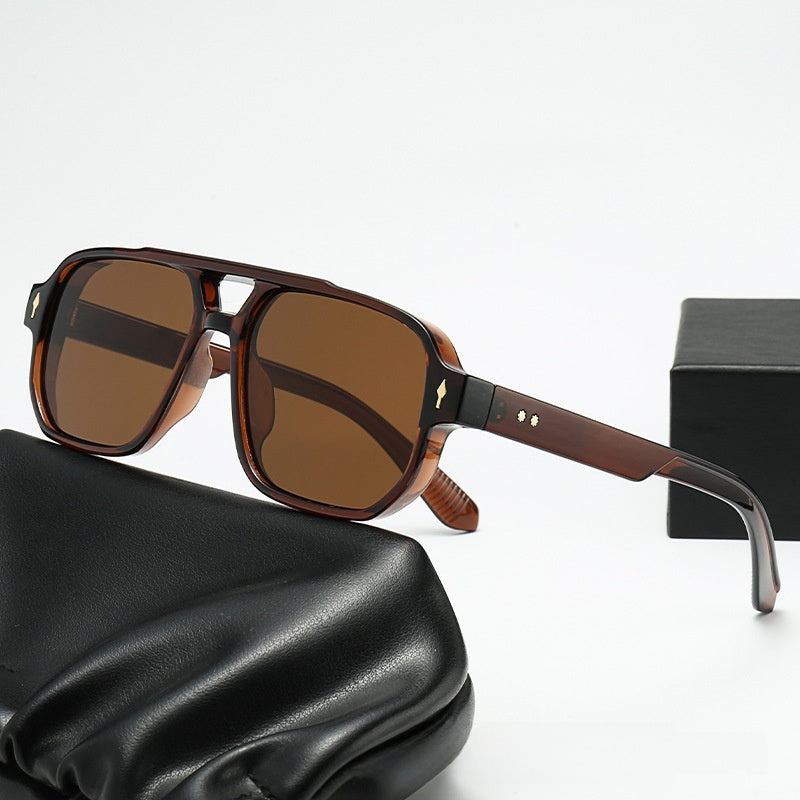 Square double bridge sunglasses with a brown frame and brown lenses beside a gift box