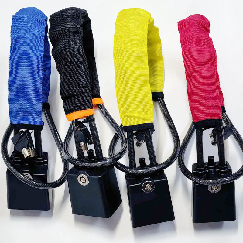 Four steering wheel cable locks in blue, black, yellow, and red with black lock bodies and keys