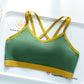 Green bra top with yellow trim and yellow crossed back straps on a white tray, Green option, size L