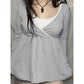 Woman in a gray long sleeve crossover V neck top over a white lace camisole, image for the Gray option in size S