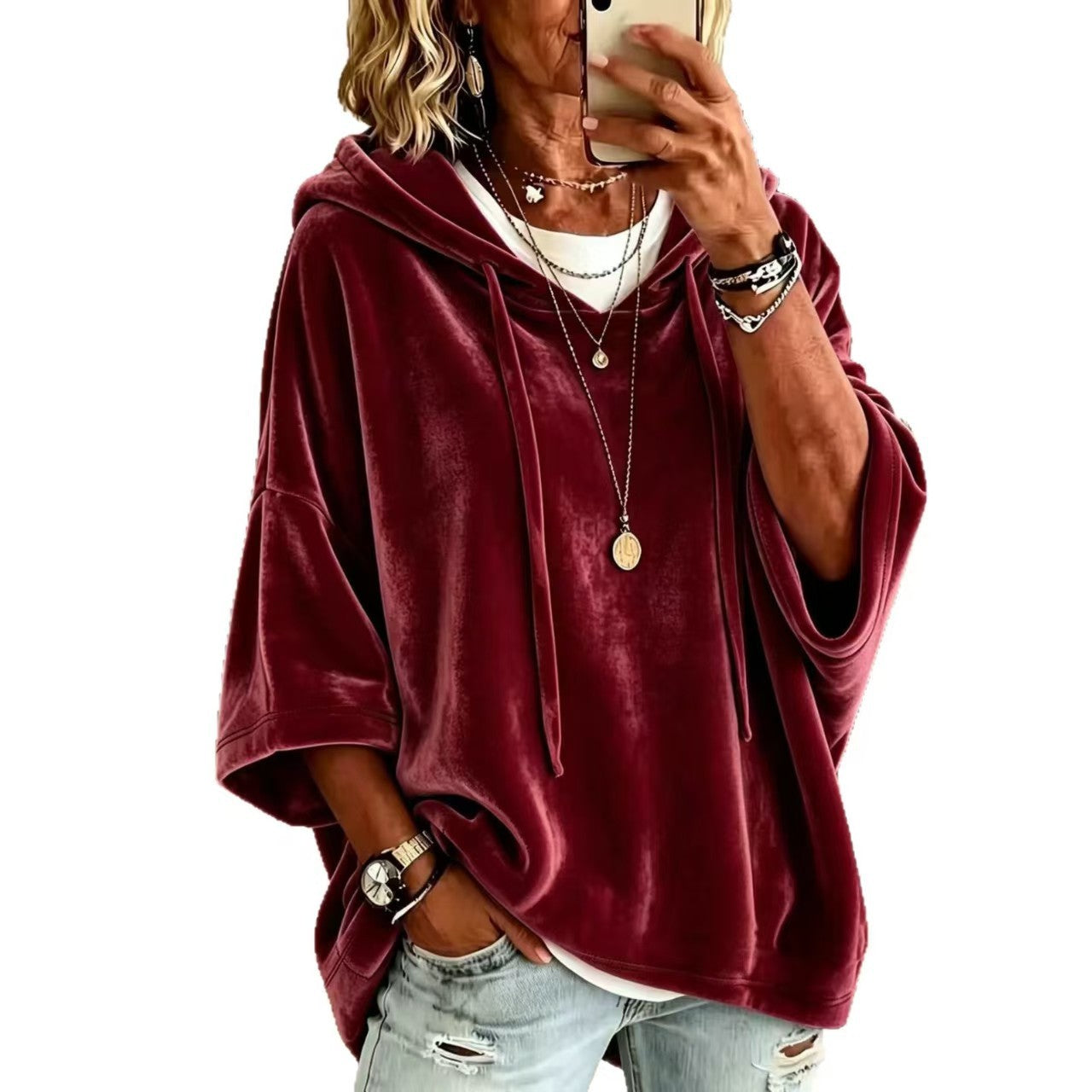 Loose womens hooded top with a drawstring hood shown on a model indoors