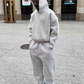 black hooded sweatshirt and trousers streetwear set shown as a full outfit