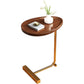 C shaped side table holding a laptop and mug at the end of a soft fabric couch