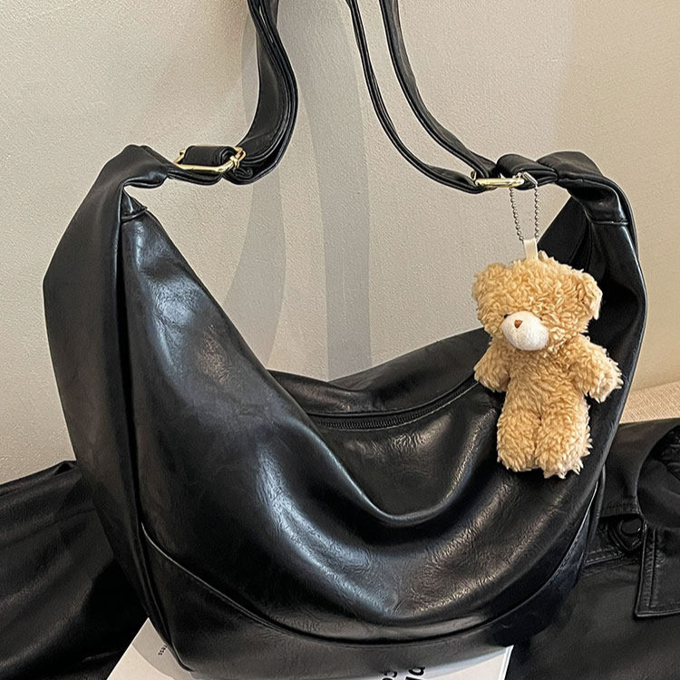 Coffee brown dumpling crossbody bag side profile shot