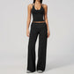 Model in a cropped camisole and wide leg fold over waist pants set, black with white polka dots