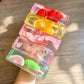 Close view of lifelike fruit set inside a clear squishy ice cube bar
