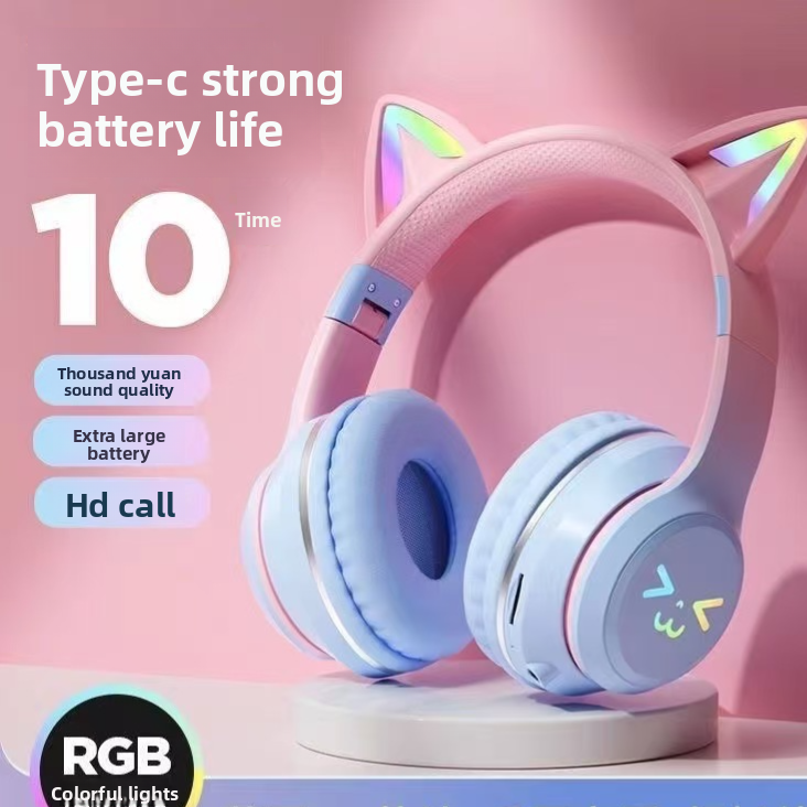 Pink gradient cat ear headphones on a round plinth with rainbow lit ears