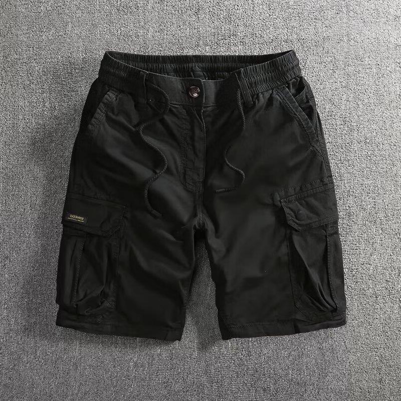 Black men's cargo shorts laid flat showing side cargo flap pockets and a drawstring waist