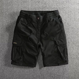Black men's cargo shorts laid flat showing side cargo flap pockets and a drawstring waist