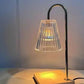 Warm amber glow from the candle warmer lamp on a shelf