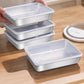 Four shallow stainless steel food trays with clear snap on lids on a wooden table