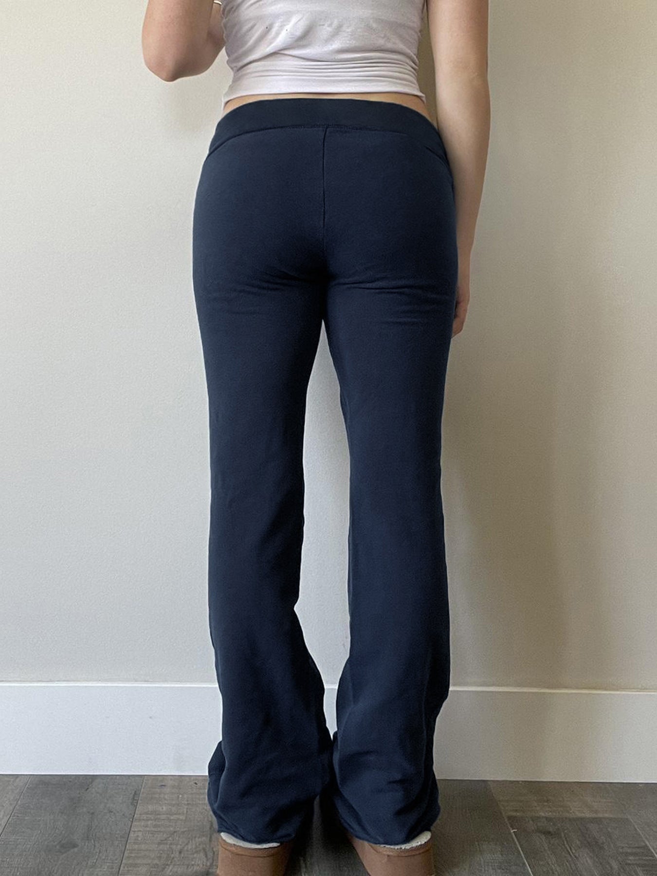 Navy flared bootcut drawstring sweatpants worn rear view showing the plain back