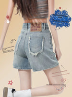 Back view of high-waisted raw-edge denim shorts in faded blue on a walking model
